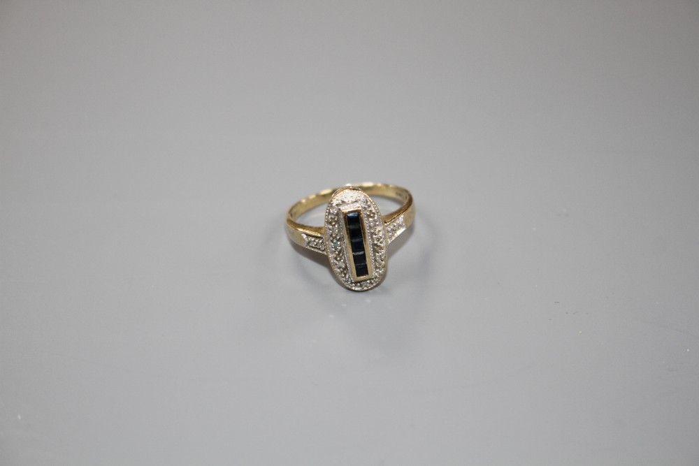 A modern Art Deco style 9ct gold, sapphire and diamond set oval dress ring, size Q/R, gross weight 3.3 grams.
